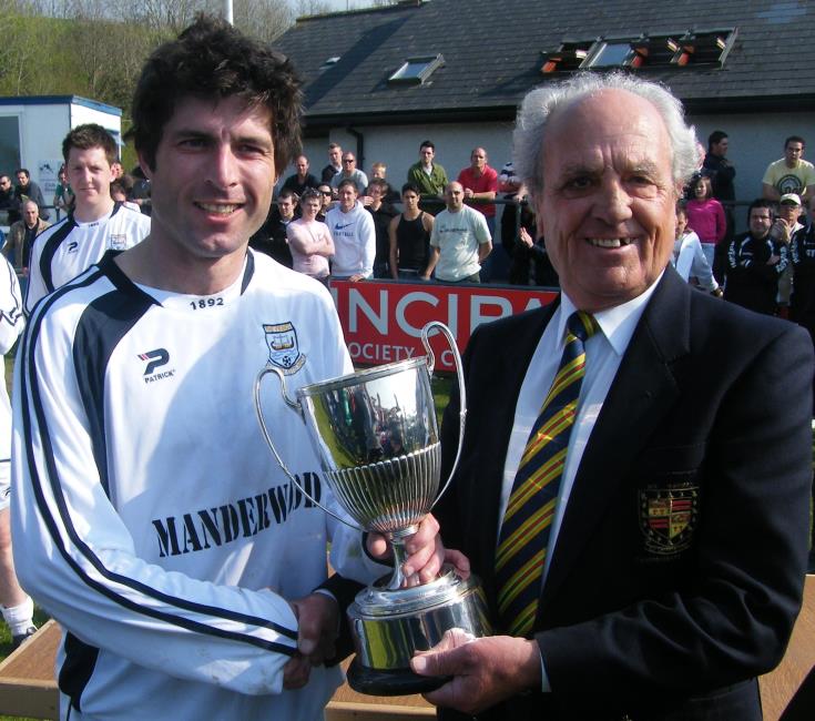Paul Jones receives Senior Cup from Eddie Oliver